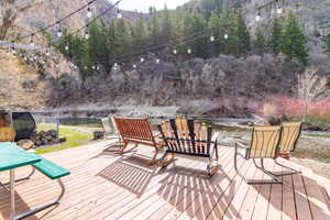 Wooden terrace featuring a mountain view and a forest view