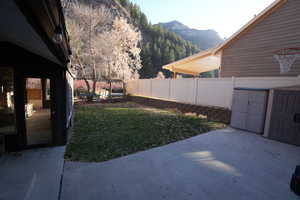 View of yard with a patio and a mountain view