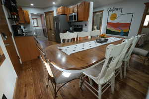 Dining space featuring plenty of natural light, separate washer and dryer, dark wood finished floors, and recessed lighting