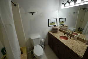 Full bath with shower / bath combination with curtain and vanity