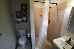 Full bath featuring a shower stall and tile patterned floors
