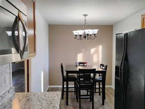 Dining room featuring light wood-style flooring and a chandelier