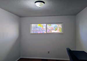 Unfurnished office featuring dark wood-style flooring and baseboards