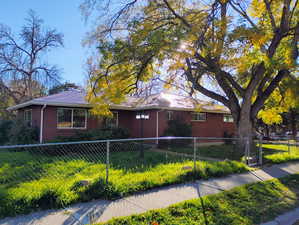 View of front of home featuring a fenced front yard and brick siding
