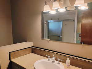 Bathroom featuring a stall shower and vanity