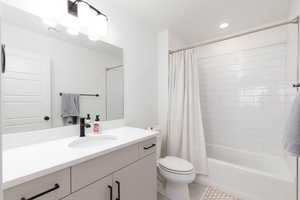 Bathroom with vanity, shower / bath combination with curtain, tile patterned flooring, and recessed lighting