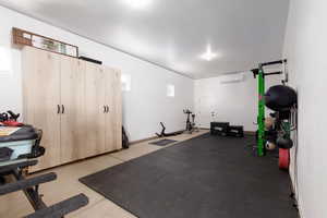 Exercise area featuring a wall unit AC