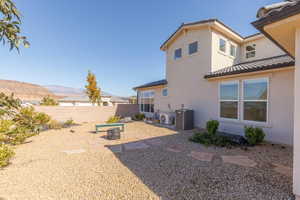 Rear view of house with a patio, stucco siding, and a tile roof