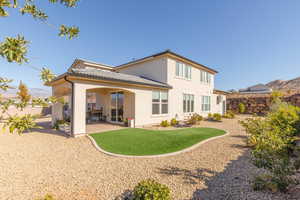 Back of property featuring a mountain view, stucco siding, and a tiled roof