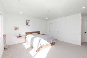Carpeted bedroom featuring a closet and recessed lighting