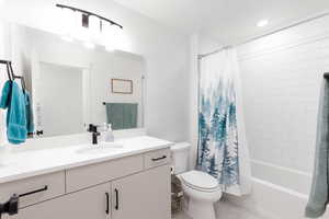 Full bath with vanity, shower / bathtub combination with curtain, light tile patterned floors, and recessed lighting