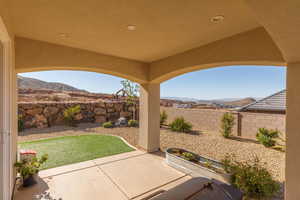 Fenced backyard with a patio area and a mountain view