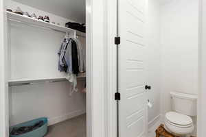 Bathroom with light carpet and a spacious closet
