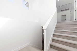 Stairs with recessed lighting and carpet