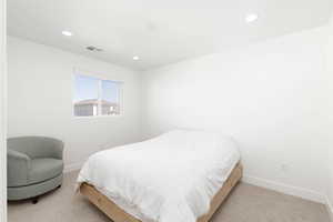 Bedroom featuring light colored carpet and recessed lighting