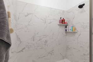 Full bathroom featuring a marble finish shower