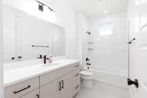 Bathroom featuring vanity, shower / bathtub combination, and light tile patterned floors
