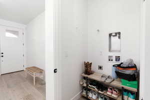 Entryway with light wood-style floors and baseboards