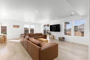 Living room featuring light wood-style flooring and recessed lighting