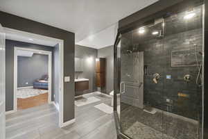 Bathroom with vanity, a stall shower, and light wood-style floors