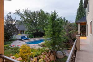 View of pool with a balcony