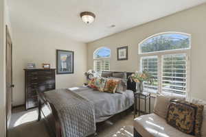 Bedroom featuring carpet and baseboards