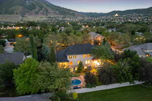 Aerial view of property's location with a mountainous background and a pool area