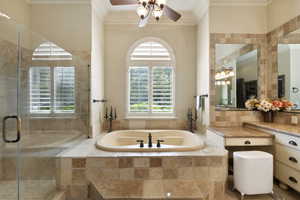 Full bathroom featuring crown molding, a garden tub, vanity, a shower stall, and ceiling fan