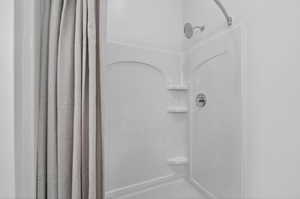 Primary bathroom with double vanity and walk in shower.