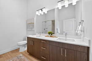 Primary bathroom with double vanity and walk in shower.