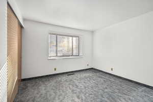 Unfurnished room with carpet and baseboards