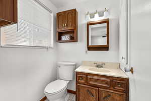 Half bathroom featuring vanity and light tile patterned flooring
