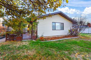 View of side of property featuring a yard
