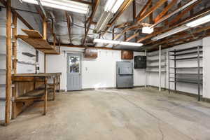Garage featuring freestanding refrigerator and baseboards