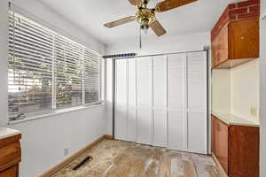 Unfurnished bedroom with a ceiling fan and a closet