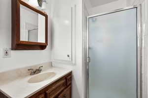 Bathroom with vanity and a stall shower