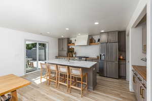 Updated kitchen complete with open shelves, and a decorative backsplash.