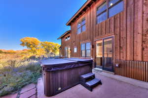 View of patio / terrace with a hot tub