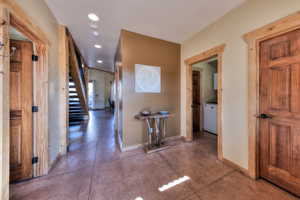 Corridor with recessed lighting and stairs