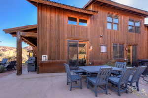 View of patio with outdoor dining area and area for grilling