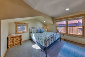 Bedroom with carpet, recessed lighting, and vaulted ceiling