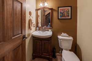 Half bathroom with vanity and toilet