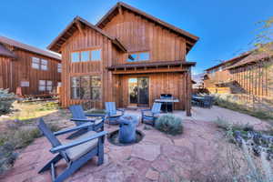 Back of house with an outdoor fire pit, a patio, and board and batten siding