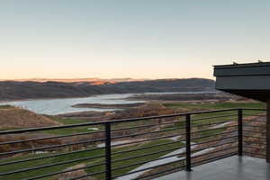 Balcony featuring a water and mountain view