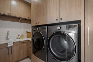 Laundry room featuring cabinet space and washer and dryer