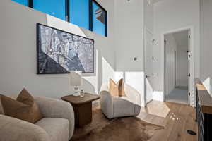 Sitting room featuring hardwood / wood-style floors and a high ceiling