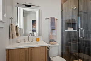 Full bathroom featuring vanity and a shower stall
