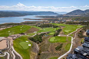 Aerial view of property's location with a water and mountain view and a local golf course