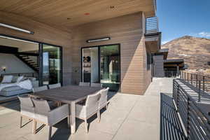 Patio / terrace with outdoor dining space, a mountain view, and a patio