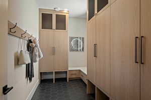 Mudroom featuring dark tile patterned flooring